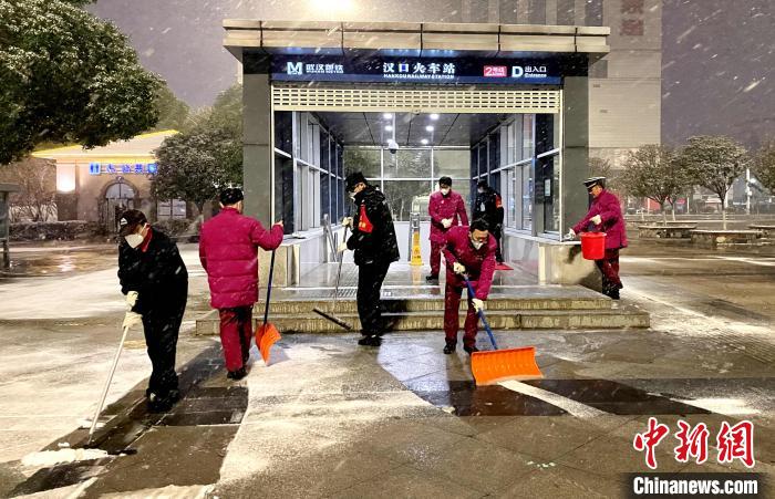 14日深夜,地铁工作人员清理出入口积雪 江曼 摄 14日深夜,地铁工作人员清理出入口积雪 江曼 摄