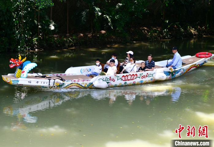 图为游客乘坐游乐龙舟观赏福州内河沿岸美景。　张斌 摄